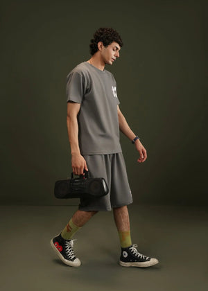 Men's charcoal grey terry t-shirt with crew neck and chest graphic print, side view.
