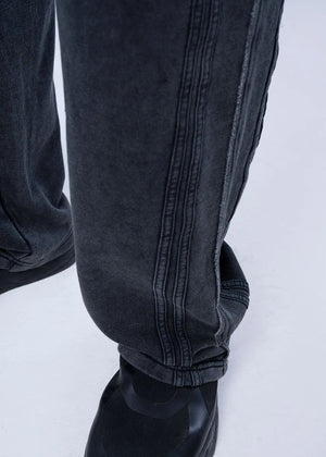 Black pull-on trouser cuff with elastic hem and vertical seam stitching