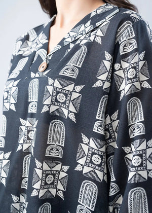Long-sleeve tunic from the co-ord set, black fabric with white geometric pattern and round neckline