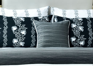 Black quilt cover with white floral vine pattern and matching square pillow