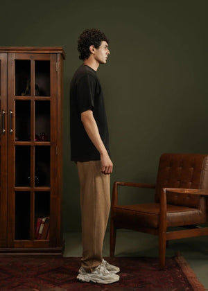 Men's black waffle-knit T-shirt, side view, short sleeves and crew neck