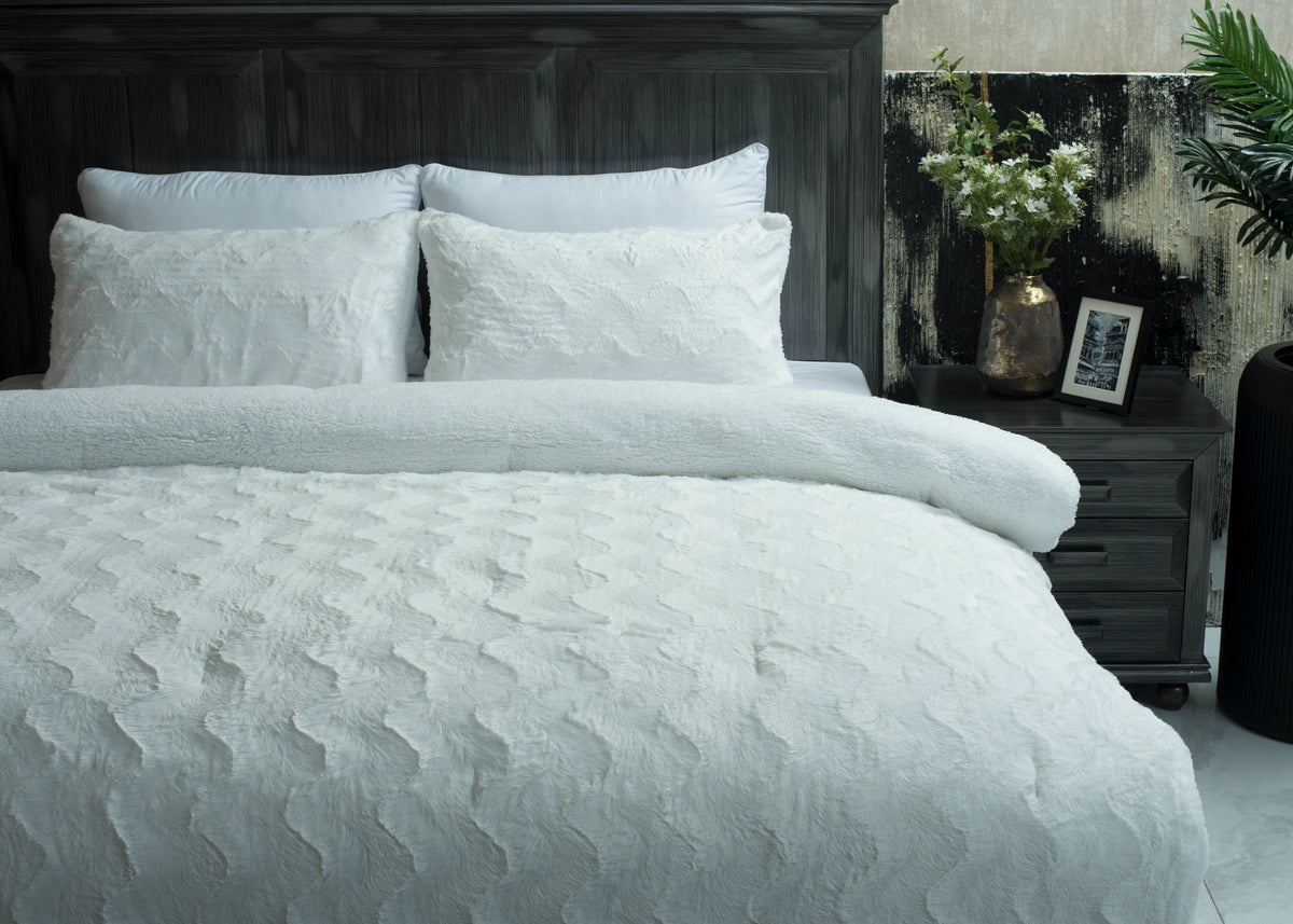Ivory 3-piece plush winter bedding set on bed with duvet and pillows