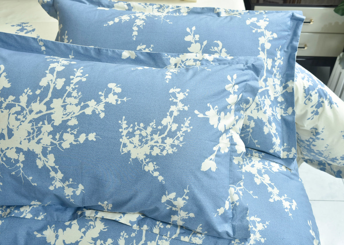 Cotton pillow cover, cloud-blue with white floral sprig print, close-up