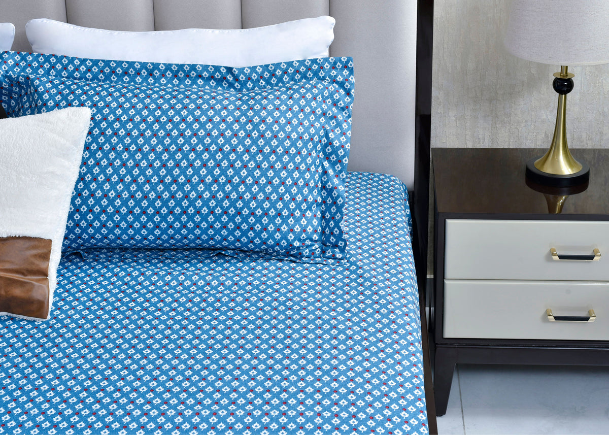 Blue Kalamkari-style bed sheet with matching pillow and white border detail