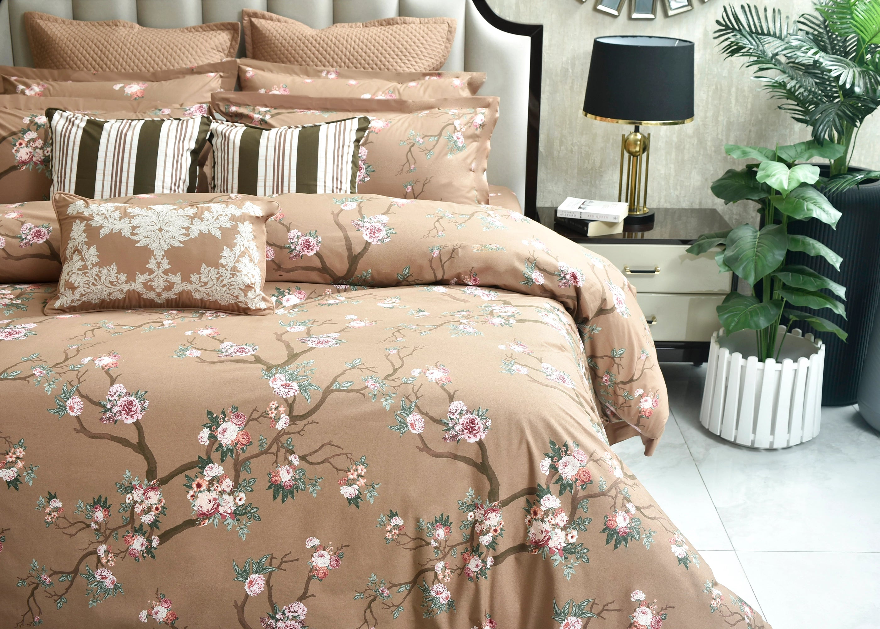 Coffee brown quilt cover with floral pattern and striped accent pillows, close-up