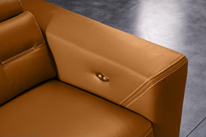 Orange leather sofa armrest with brass button detail and double-row stitching