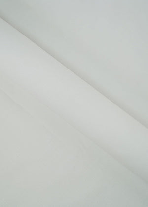 Off-white dobby fabric panel with subtle geometric weave, draped diagonally