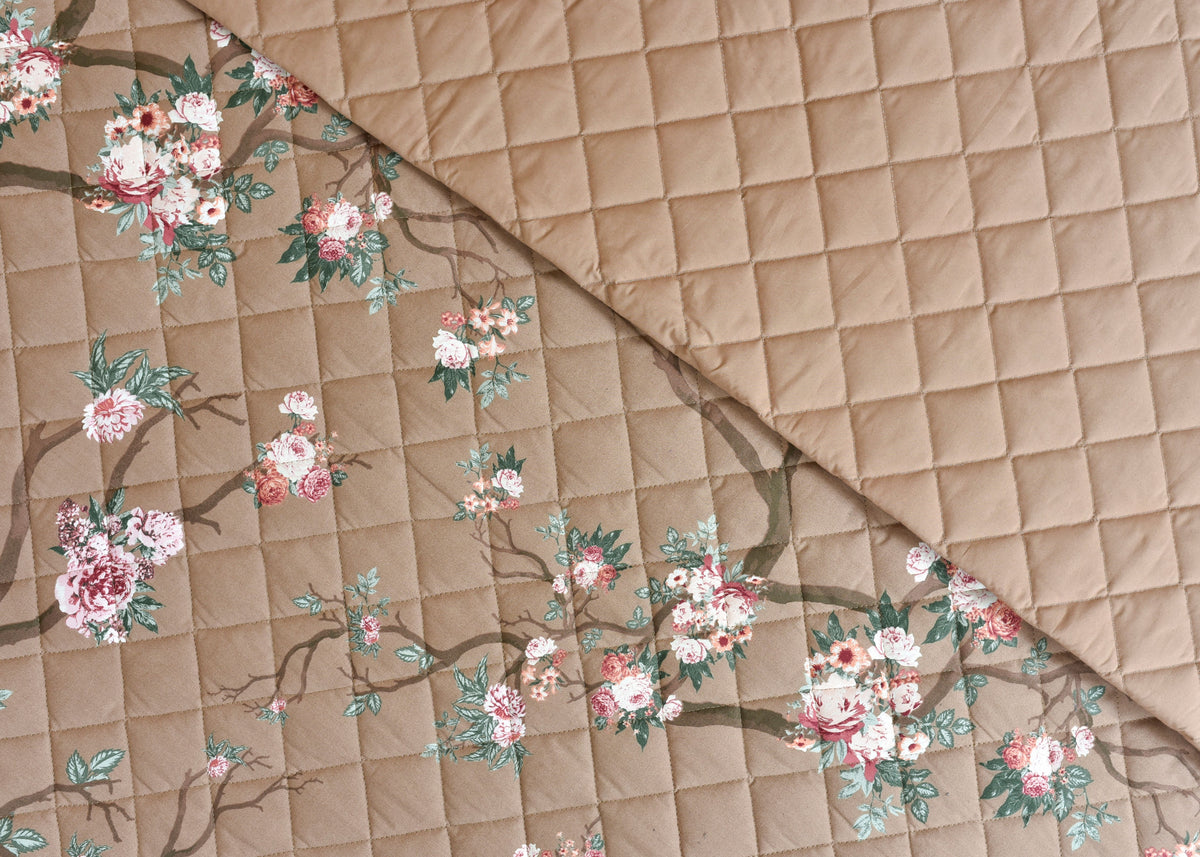 Coffee-brown quilted bedspread with floral bouquet print and stitched diamond pattern