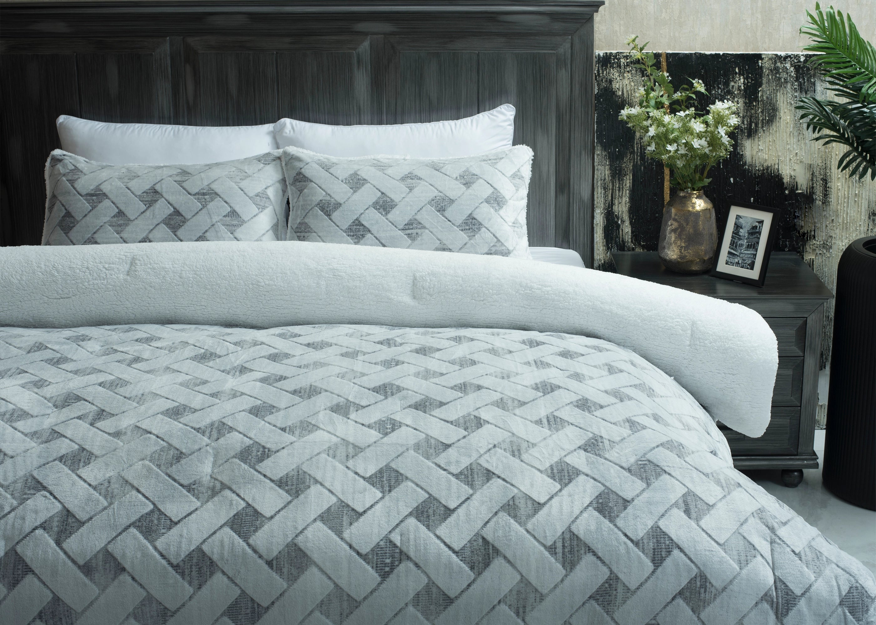 Quilted bedspread with light chevron stitch pattern and two matching decorative pillows