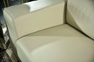 Cream cushioned sofa seat with visible stitching and curved armrest