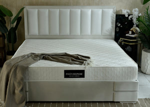 Pocket spring mattress with white quilted top and POSTUREPEDIC label