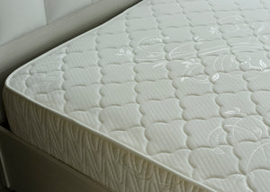 White pocket spring mattress with stitched edge detail and textured top surface