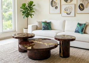 Brass-inlaid dark wood round coffee table set with three nesting tables