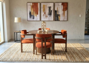 Breakfast table set with round wood table and four orange upholstered chairs