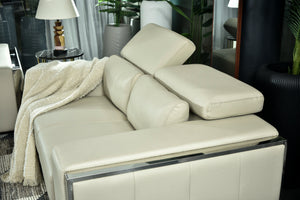 Cream leather-look chaise sofa with raised backrest and arm pillow