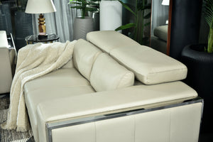 Cream chaise sofa with reclining backrest and contoured seat cushion