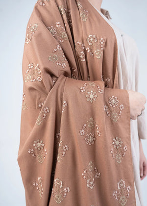 Women's brown wool winter shawl, floral embroidery, draped over shoulder