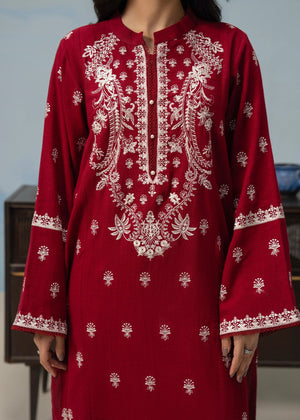 Close-up of maroon embroidered kurta neckline and button placket with sleeve borders
