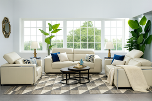 Cream upholstered sofa set with three-seat chaise and blue accent cushions
