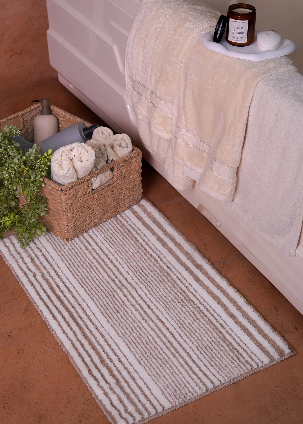Brown striped polyester bath mat with textured loop pile, rectangular rug.