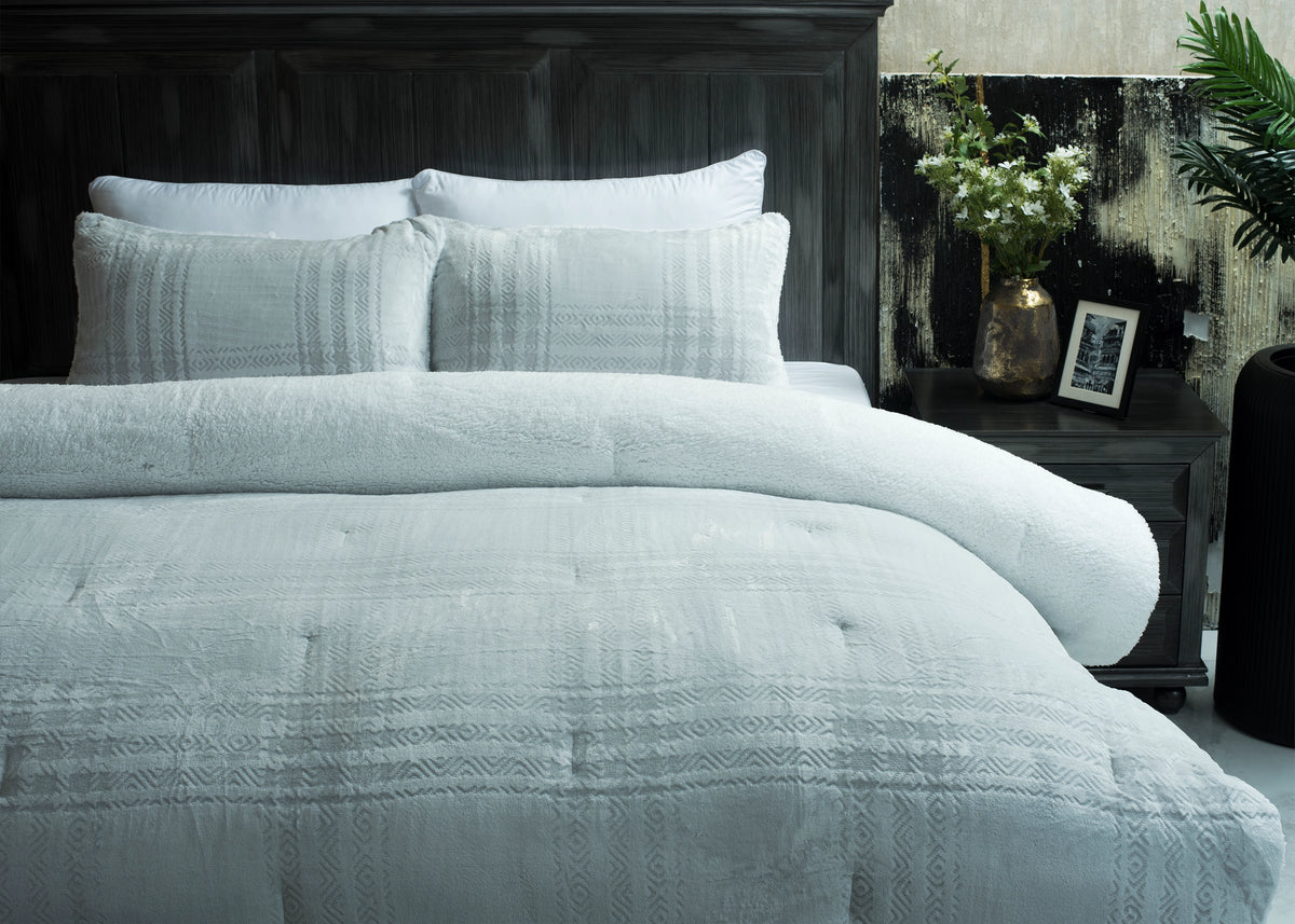 Light grey bedding set with carved patterned duvet and two matching pillow shams