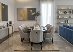 Dining table with centerpiece and six upholstered chairs in a modern dining room