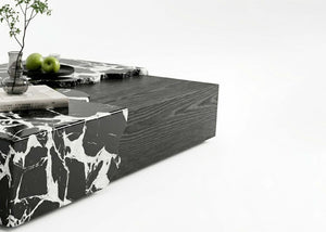 Portoro marble center table corner detail with white veining on black stone and dark sides