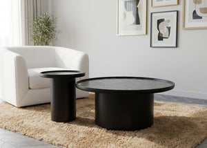 Pair of round nesting tables with matte black legs and dark gray tabletops