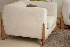 Boucle fabric sofa armchair with curved back, rounded seat, and light wood legs