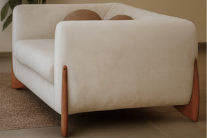 Boucle fabric sofa corner with curved arms, plush back cushion, and light wood legs