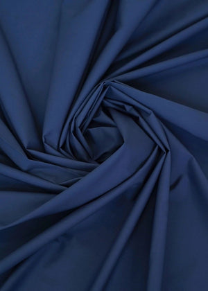 Navy wash-and-wear winter fabric, close-up with gathered fold texture