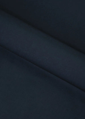 Dark black wash-and-wear fabric close-up with smooth drape