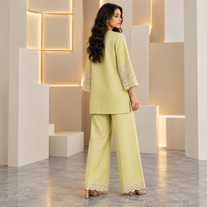 Lime green women's co-ord set with textured tunic and wide-leg pants, eyelet lace hems