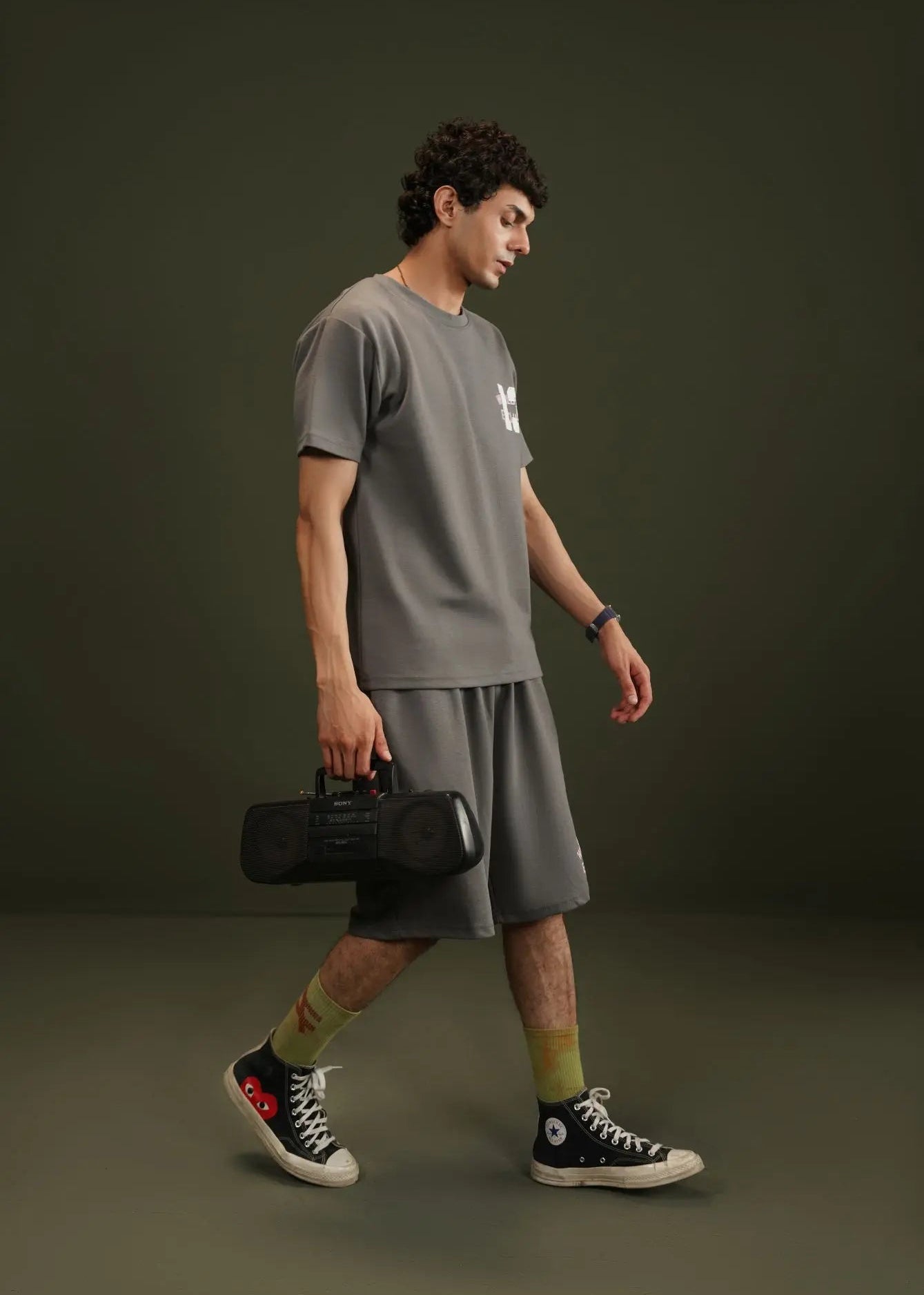 Men's charcoal grey terry t-shirt with crew neck and chest graphic print, side view.