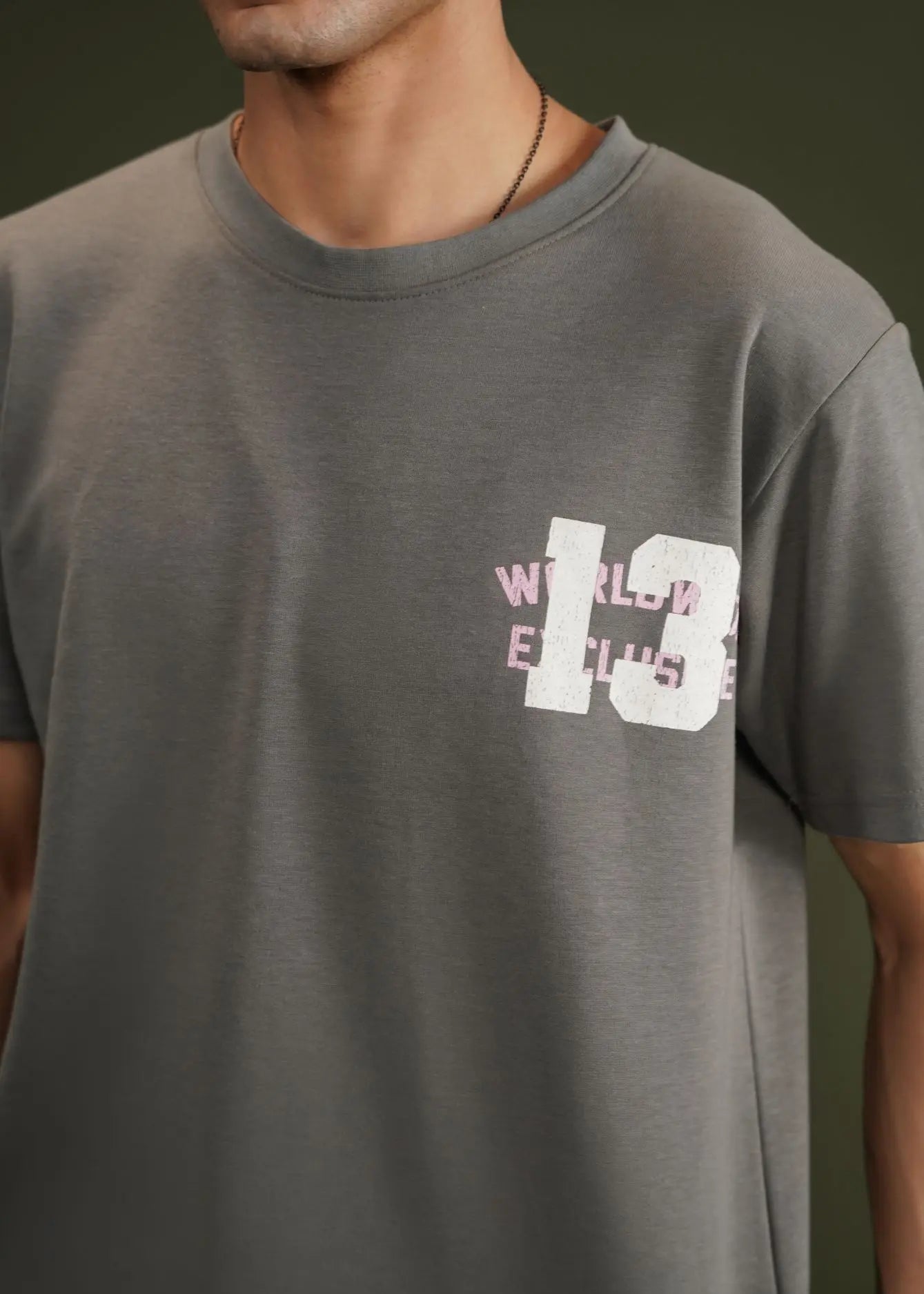 Charcoal grey terry crew-neck t-shirt with chest graphic print, close-up.