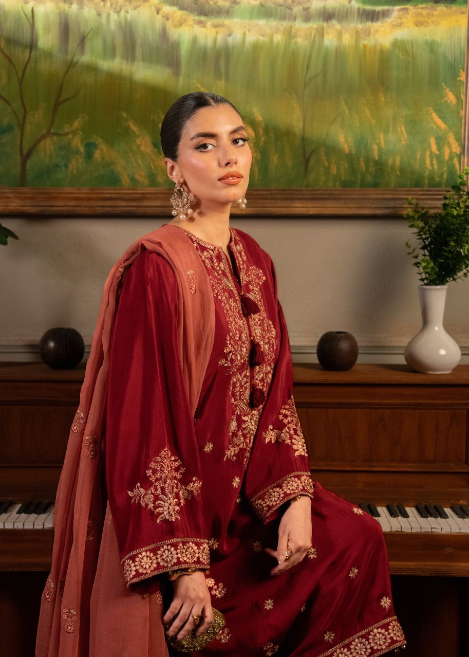 Women's maroon embroidered kurta and dupatta with ornate gold detailing and pants