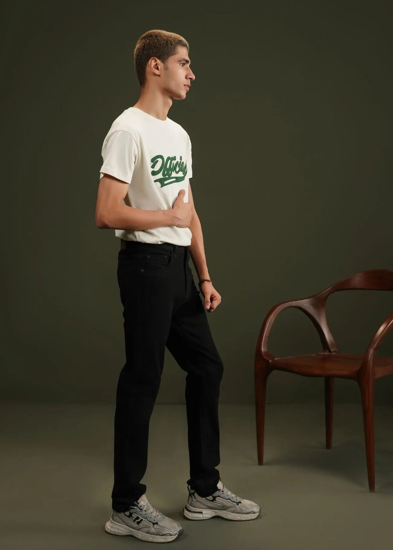 Black men's winter chino pants with cuffs, belt loops, and side pocket stitching.