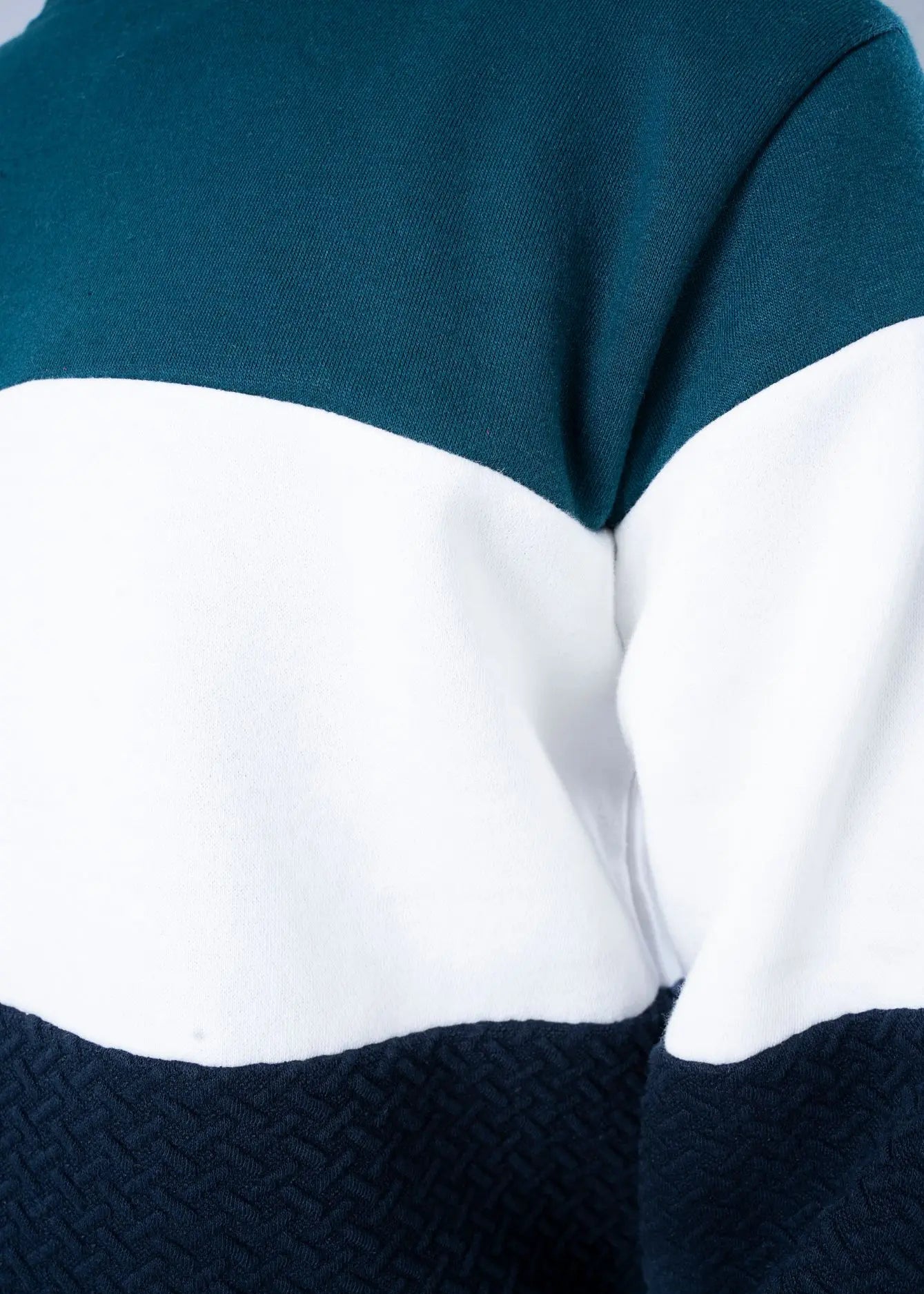 Fleece sweatshirt close-up: green, white, and navy color-block stripes