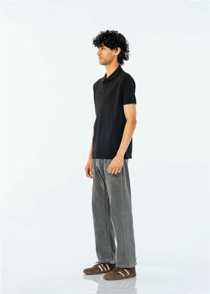 Men's black cotton pique polo shirt, side view, short sleeves with button collar