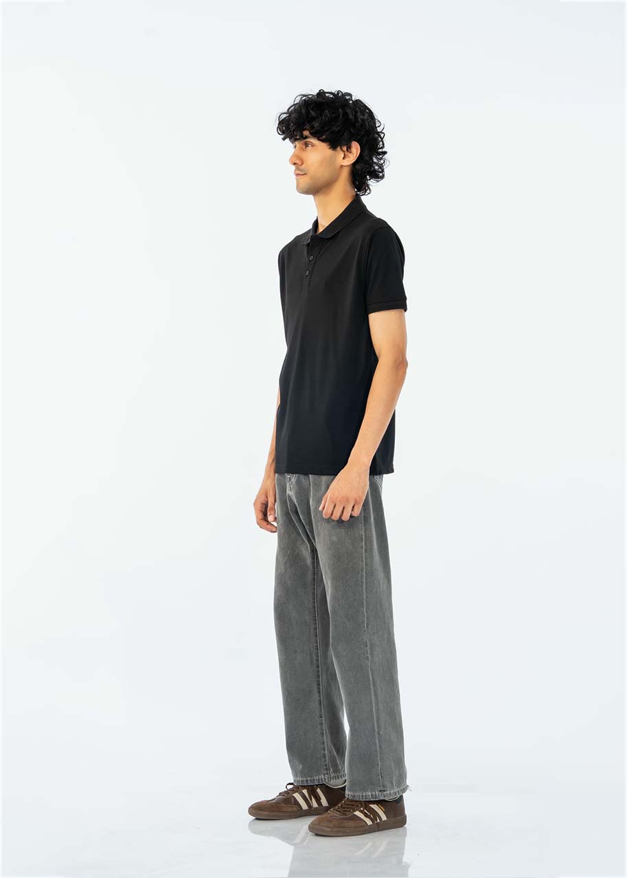 Men's black cotton pique polo shirt, side view, short sleeves with button collar