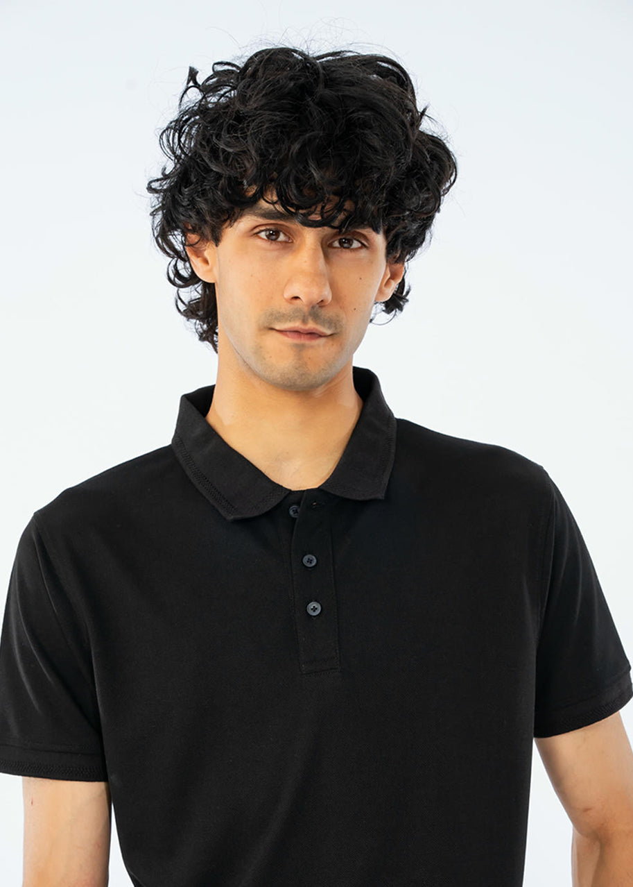 Men's black cotton pique polo shirt close-up, three-button placket and ribbed collar