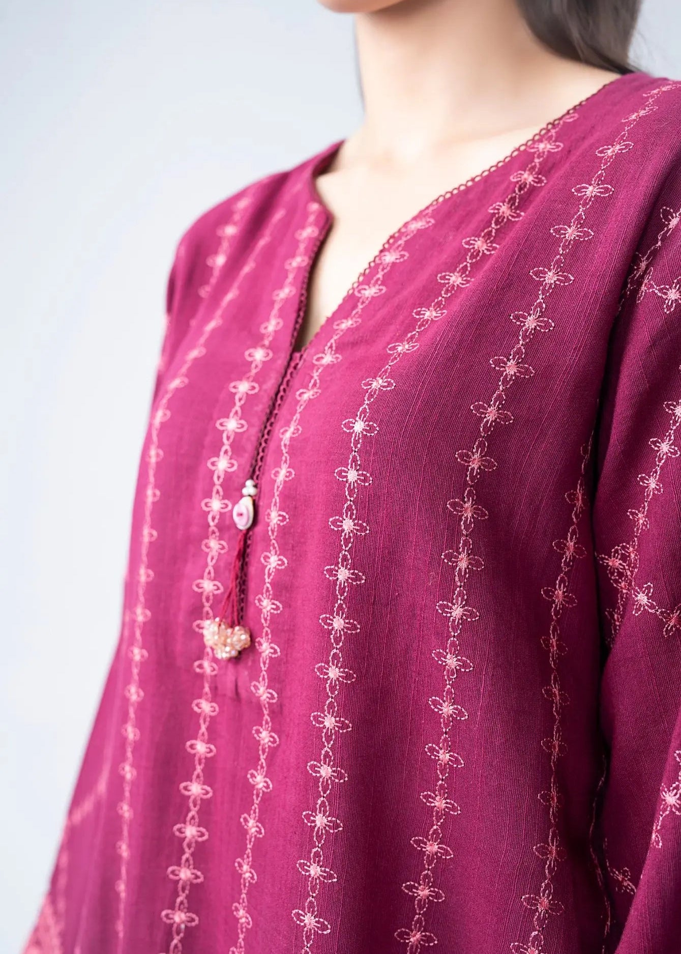 Maroon embroidered kurta neckline with delicate cross-stitch pattern