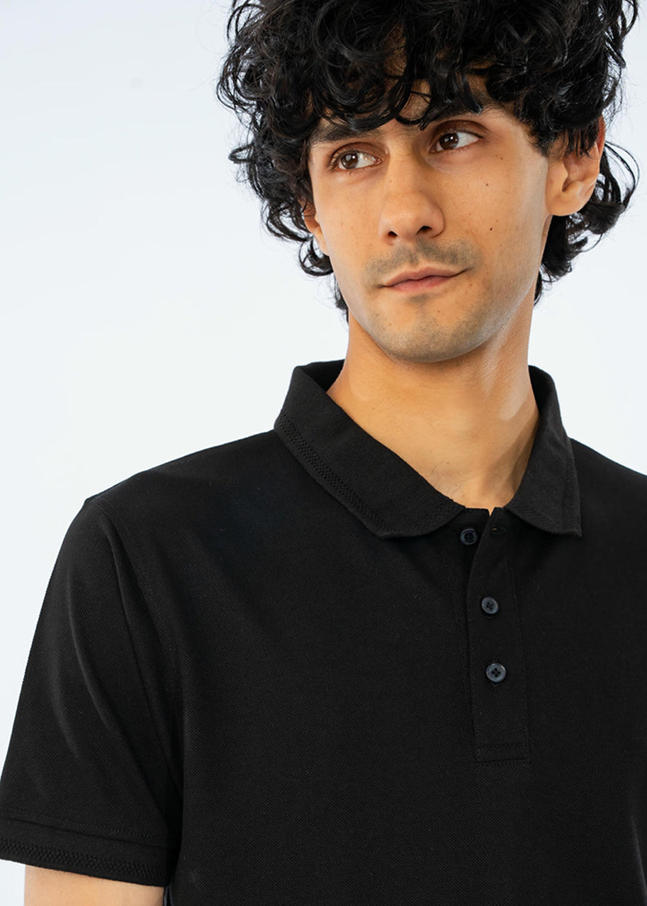 Men's black cotton pique polo shirt close-up of collar, button placket detail