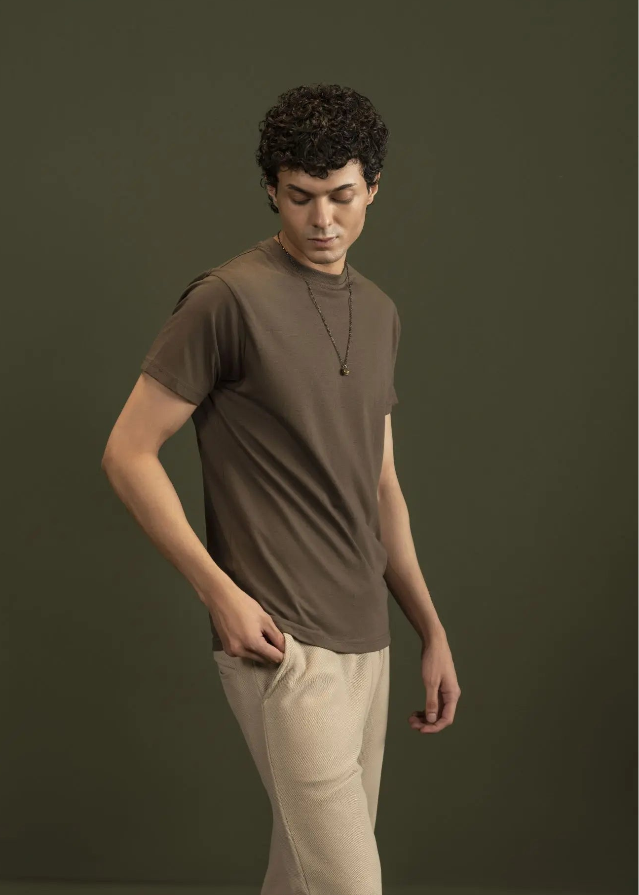 Men's olive crew-neck T-shirt with short sleeves, close-up torso view