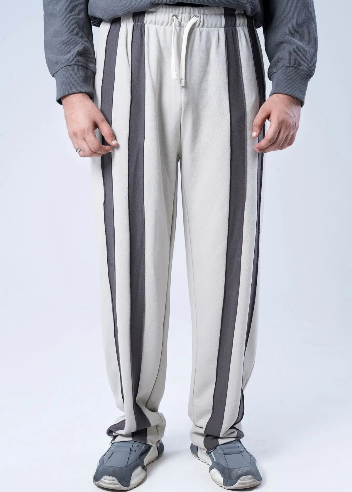Winter pull-on trousers with bold charcoal vertical stripes on off-white; elastic waist
