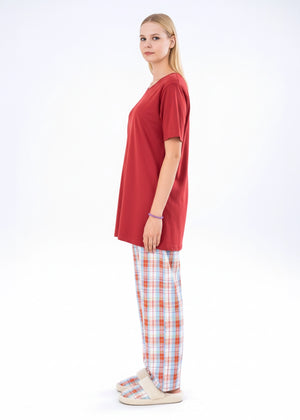 Women's winter night suit with maroon short-sleeve top and red plaid trousers, side view