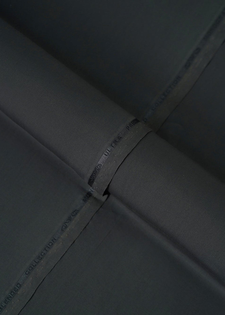 Black fabric with stitched seam and printed label on the edge