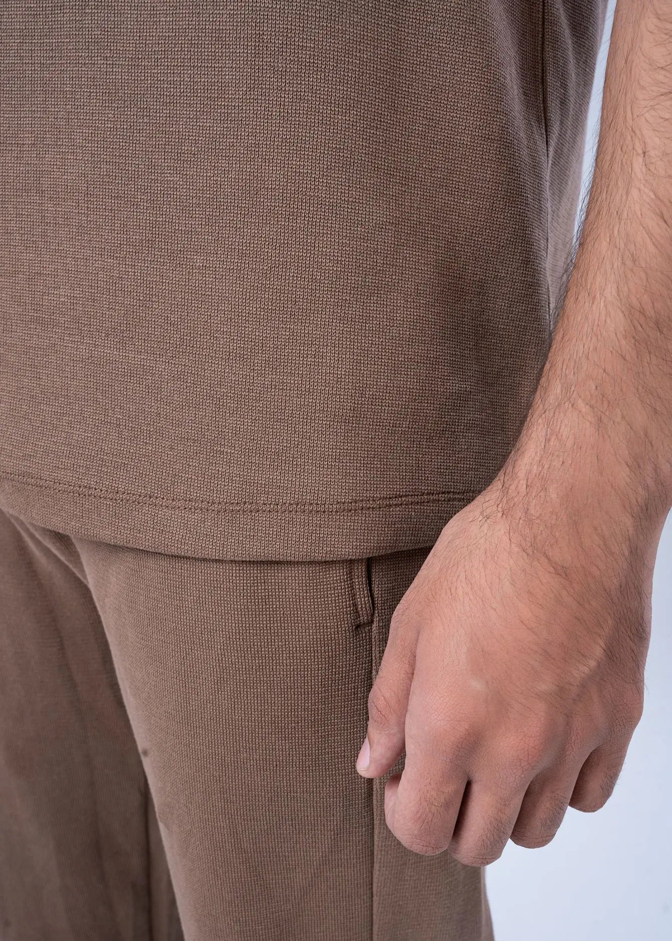 Brown textured knit T-shirt hem with pants waistband detail