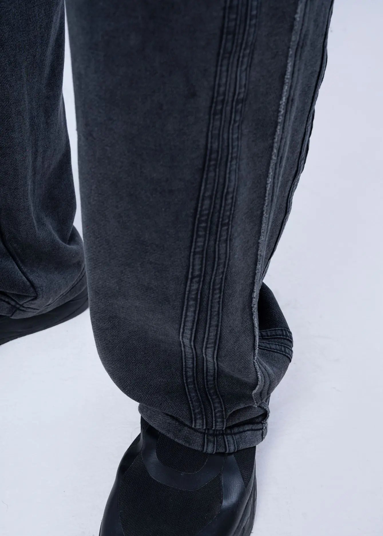 Black pull-on trouser cuff with elastic hem and vertical seam stitching