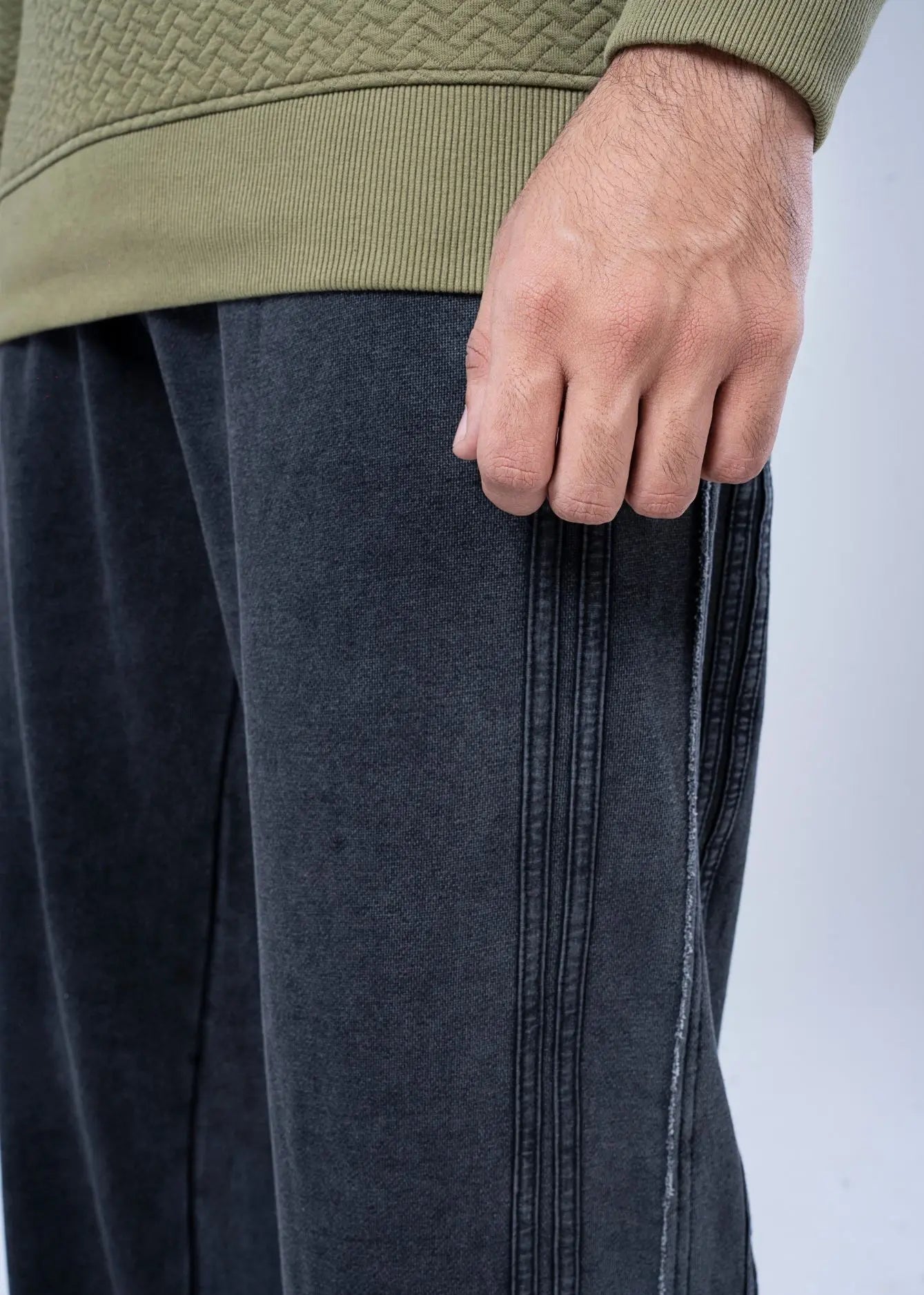 Black pull-on trousers close-up of pocket area and vertical seam detailing